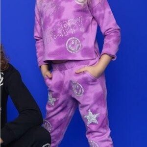 Purple sweatsuit with silver glitter embellishments.